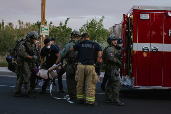 Tactical police officers assist the paramedics as they load Scott Williams into an ambulance after he was shot by Steven Ray Baca during a protest where opposing groups, including a militia, clashed in Albuquerque, NM on June 15, 2020. Baca was allegedly assaulting multiple protestors at the demonstrations calling for the removal of a statue of Don Juan de O&ntilde;ate, a Spanish conquistador known for his brutal treatment of indigenous people. After assaulting a woman, Williams and fellow protestors began chasing Baca, who was conceal carrying a firearm. Baca shot Williams several times in his torso.
