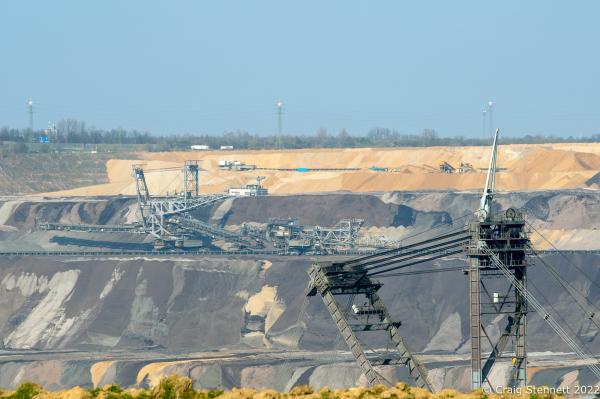 L&Uuml;TZERATH, GERMANY- MARCH 23: A coal mining machines in the Garzweiler lignite open cast mine on March 23, 2022 near the village of L&uuml;tzerath, Nordrhein-Westfalen, Germany. In the background is the village of Keyernberg. An enviromental camp &#39;Mahnwache L&uuml;tzerath&#39; (Vigil L&uuml;tzerath) was set up in 2020 on the land of L&uuml;tzerath Farmer Eckart Heukamp to protest against the expansion of the Garzweiler open-cast lignite mine. Most of the former properties in L&uuml;tzerath have already been demolished to make way for the mine but Eckart Heukamp has contested the RWEs (the energy provider who owns the mine) right to forcibly take his farm. The case is currently progressing through the German court system. (Photo by Craig Stennett/Getty Images)