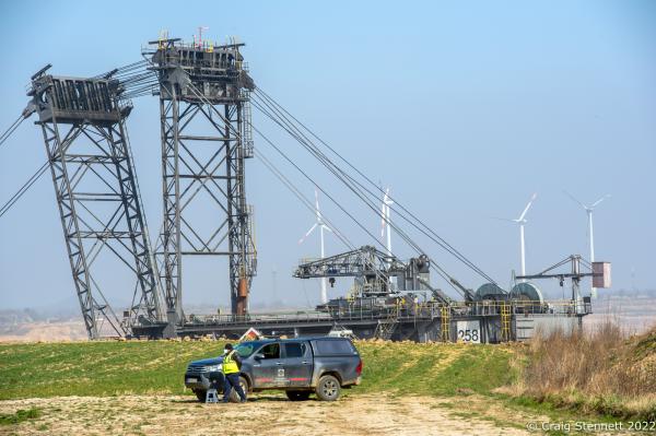 L&Uuml;TZERATH, GERMANY- MARCH 24: A security guard keeps watch over a coal mining machine from the Gazweiler lignite open cast mine on March 24, 2022 in L&uuml;tzerath, Nordrhein-Westfalen, Germany. An enviromental camp &#39;Mahnwache L&uuml;tzerath&#39; (Vigil L&uuml;tzerath) was set up in 2020 adjacent to the open cast mine on the land of L&uuml;tzerath Farmer Eckart Heukamp to protest against the expansion of the Garzweiler open-cast lignite mine. Most of the former properties in L&uuml;tzerath have already been demolished to make way for the mine but Eckart Heukamp has contested the RWEs (the energy provider who owns the mine) right to forcibly take his farm. The case is currently progressing through the German court system. (Photo by Craig Stennett/Getty Images)