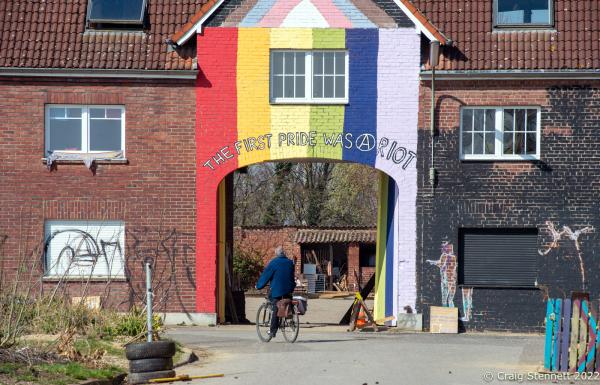 L&Uuml;TZERATH, GERMANY- MARCH 26: A cyclist passes one of the remaining buildings now occupied by enviromental protesters on March 26, 2022 in L&uuml;tzerath, Nordrhein-Westfalen, Germany. An environmental camp was set up at the village in 2020 on the land of L&uuml;tzerath Farmer Eckart Heukamp to protest against the expansion of the Garzweiler open-cast lignite mine. Most of the former properties in L&uuml;tzerath have already been demolished to make way for the mine but property owner Eckart Heukamp has contested the RWEs (the energy provider who owns the mine) right to forcibly take his farm. The case is currently progressing through the German court system. The enviromentalists and their camp is intended to give support to Eckart Heukamp and opposition to any forcible attempt to clear his farm and land. (Photo by Craig Stennett/Getty Images)