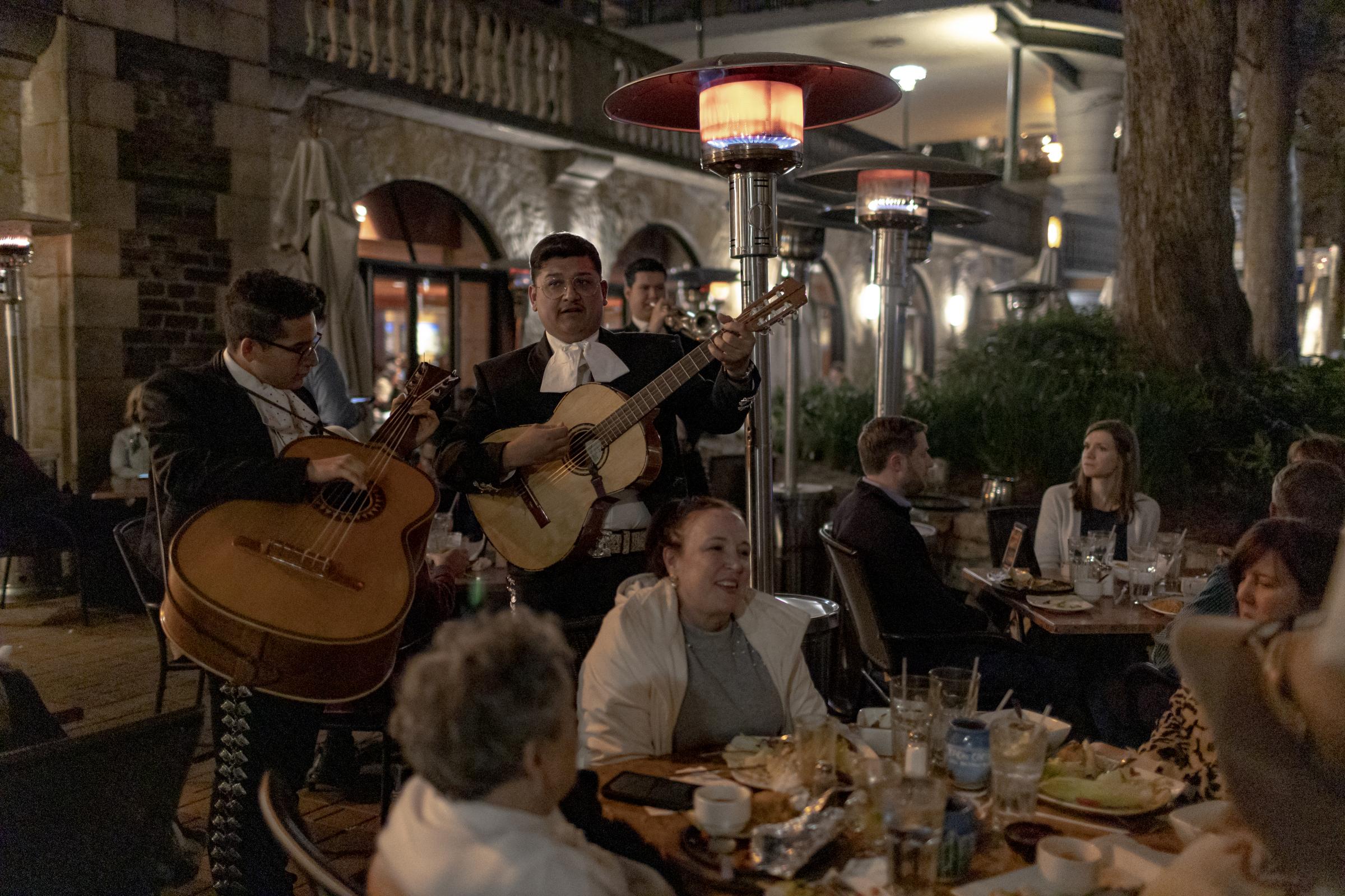 A group of mariachis performs in front of dinner guests at a local restaurant in San Antonio, Texas, 01/4/2022. While the omicron variant of the COVID-19 virus rapidly spikes in American Cities, Texas does not require masks to be worn in public, or for public places to be monitored.