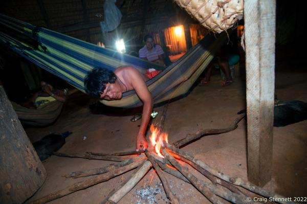 LAPETANHA, BRAZIL-OCTOBER 25: Amazonian indegenous indian Gasmasakaka Surui of the Paiter-Surui tribe attends to the night&#39;s fire in the communal area of his village of Lapetanha in the &quot;7th September Indian Reserve&quot; Rond&ocirc;nia, Brazil on October 25th, 2010. The tribe had a 50 year plan to halt illegal logging on their land and plant a million trees in order to return their part of the Amazon rainforest back to its pristine condition through the financing earned from carbon offsetting. Indigenous people have contributed less to climate change than has any other section of the population, yet they are among those most in jeopardy from its impacts. REDD+ stands for &ldquo;Reducing Emissions from Deforestation and Degradation&quot; and it is enshrined in the 2015 Paris Climate Agreement. The &quot;Forest Carbon Project&quot;, was initiated by the Patier-Surui in 2009 and was the first indigenous-led conservation project financed through the sale of carbon offsets. It dramatically reduced deforestation within the territory of the Paiter-Surui during the first five years of operation (2009-2014), but was suspended in 2018 after the discovery of large gold deposits in the territory that sparked a surge in deforestation and a fracture in the indigenous tribe&#39;s unity on how to proceed. (Photo by Craig Stennett/Getty Images)