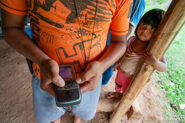 LAPETANHA, BRAZIL-OCTOBER 26: Mopidmore Surui of the Paiter-Surui indegenous indian tribe holds a GPS device he will be taking into the Amazon rainforest to map its carbon content while his daughter Soeytxer watches. At the Paiter-Surui village of Lapetanha in the &quot;7th September Indian Reserve&quot; Rond&ocirc;nia, Brazil on October 26th, 2010. The tribe had a 50 year plan to halt illegal logging on their land and plant a million trees in order to return their part of the Amazon rainforest back to its pristine condition through the financing earned from carbon offsetting. Indigenous people have contributed less to climate change than has any other section of the population, yet they are among those most in jeopardy from its impacts. REDD+ stands for &ldquo;Reducing Emissions from Deforestation and Degradation&quot; and it is enshrined in the 2015 Paris Climate Agreement. The &quot;Forest Carbon Project&quot;, was initiated by the Patier-Surui in 2009 and was the first indigenous-led conservation project financed through the sale of carbon offsets. It dramatically reduced deforestation within the territory of the Paiter-Surui during the first five years of operation (2009-2014), but was suspended in 2018 after the discovery of large gold deposits in the territory that sparked a surge in deforestation and a fracture in the indigenous tribe&#39;s unity on how to proceed. (Photo by Craig Stennett/Getty Images)