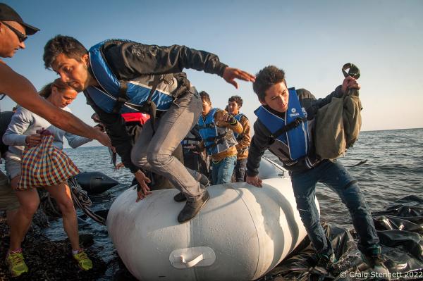 EFTALOU, GREECE-SEPTEMBER 21: Refugees disembark after crossing the Aegean Sea from Turkey by dingy. Arriving at Limanaki Beach in Eftalou, Lesbos, Greece in 2015. Helped by Greek national Agillios Billos who used his holiday time from work to volunteer as a refugee helper on the Greek Island of Lesbos. In all, over 1 million refugees and migrants crossed the Mediterranean (mostly the Aegean Sea) in 2015, three to four times more than the previous year. 80% were fleeing from wars in Syria, Iraq, and Afghanistan. About 85% of sea arrivals were in Greece via Turkey.(Photo by Craig Stennett/Getty Images)