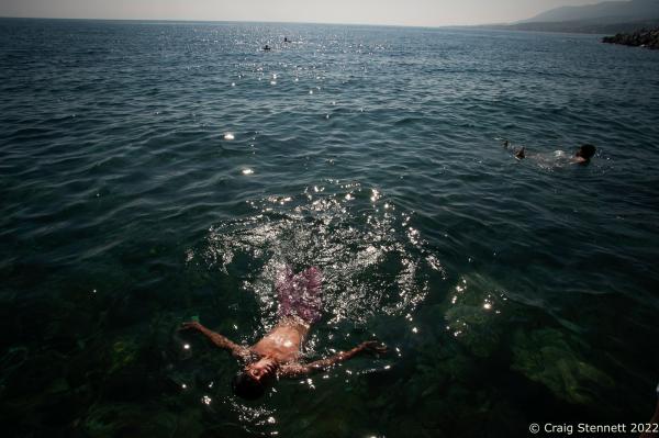 MYTILENE, GREECE-SEPTEMBER 17: With temperatures hitting 34 degrees centigrade at the Port of Mytilene on the Greek Island of Lesbos. Refugees from the 2015 Syrian war cool down in the Aeghean sea while awaiting theri documentation processing and further transport into mainland Greece. (Photo by Craig Stennett/Getty Images)