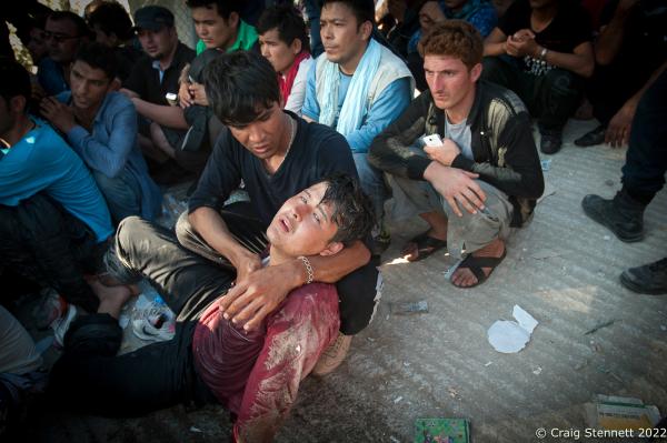 MORIA REFUGEE CAMP, GREECE-SEPTEMBER 18: A refugee collapses from the heat and exhaustion while waiting in line to process his Asylum application papers at Moria Refugee Camp, Lesbos in 2015. (Photo by Craig Stennett/Getty Images)