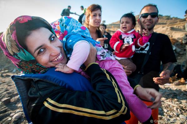 EFTALOU, GREECE-SEPTEMBER 20: An Afghan woman is reunited with her child on arrival at Limanaki Beach in Eftalou, Lesbos, Greece in 2015 after making a dingy crossing of the Aegean Sea from Turkey.. She was met by a small group of volunteer aid workers, who distribute water and arrange transport,if possible, for the extra 40 kilometers she must travel to Moria or KaraTepe Registration camp in order to process her Asylum application and proceed further into mainland Europe. In all, over 1 million refugees and migrants crossed the Mediterranean (mostly the Aegean Sea) in 2015, three to four times more than the previous year. 80% were fleeing from wars in Syria, Iraq, and Afghanistan. About 85% of sea arrivals were in Greece via Turkey.(Photo by Craig Stennett/Getty Images)