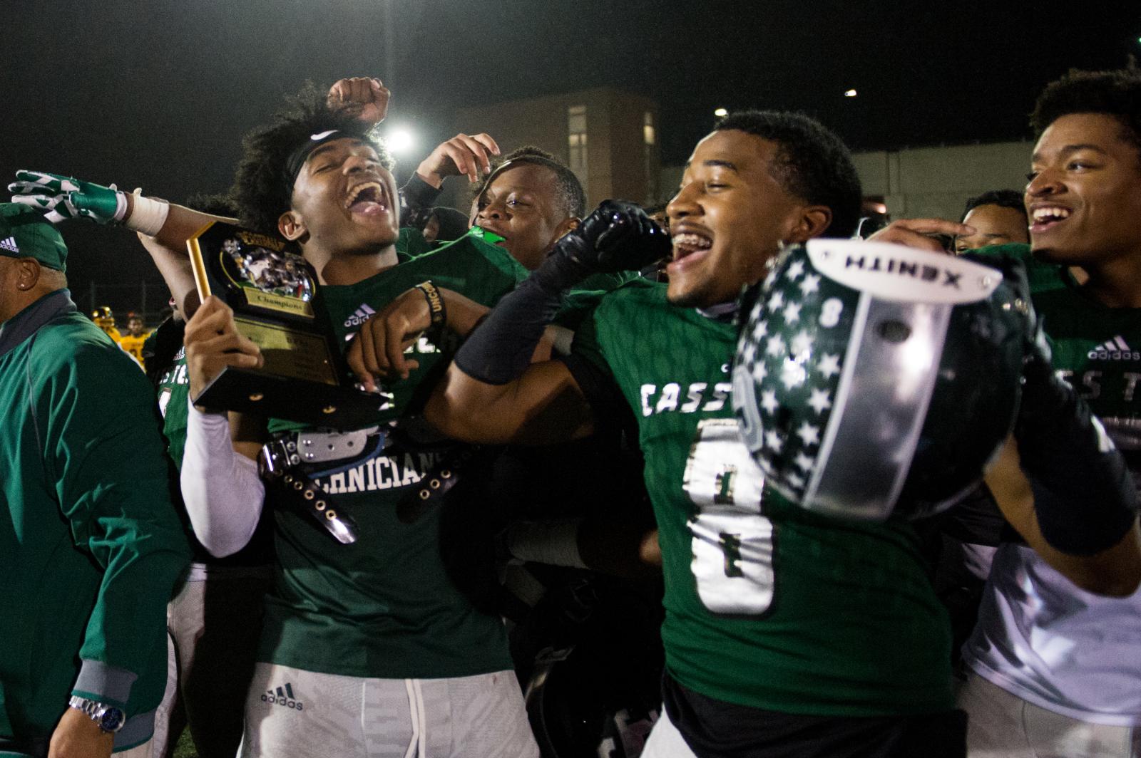 Cass Tech players Jeran Mangham, 1, and Tyler Milliner, 8, celebrate their victory over King...