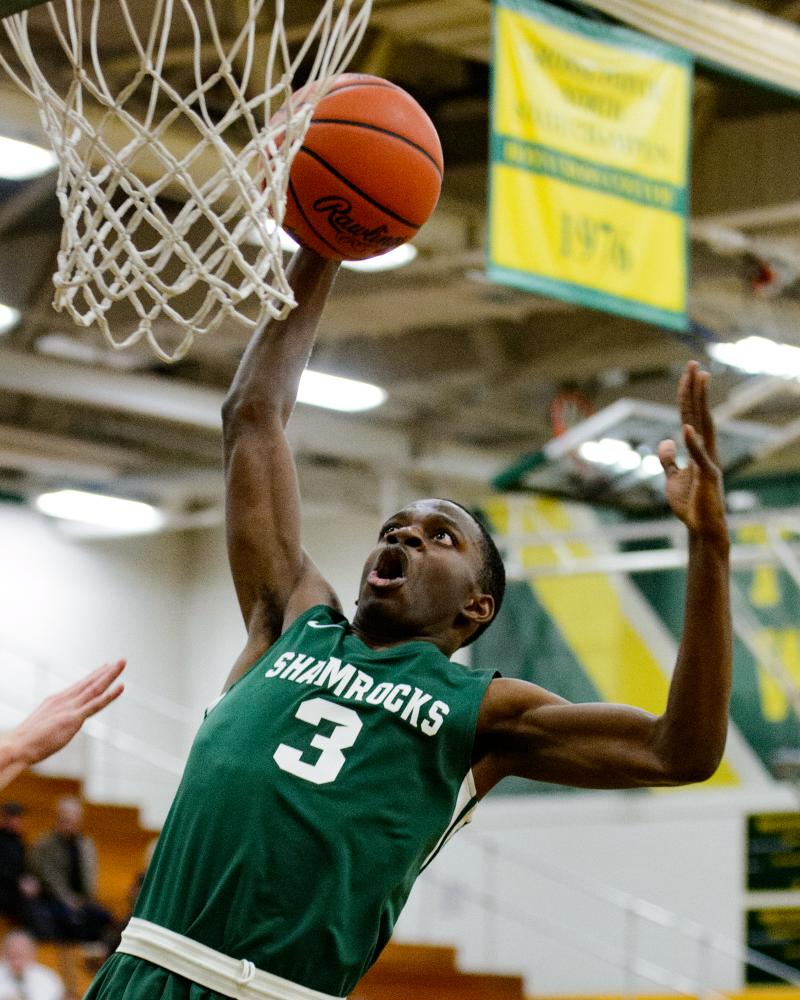 Sports - Eastpointe High School's Davon Yelder dunks during...