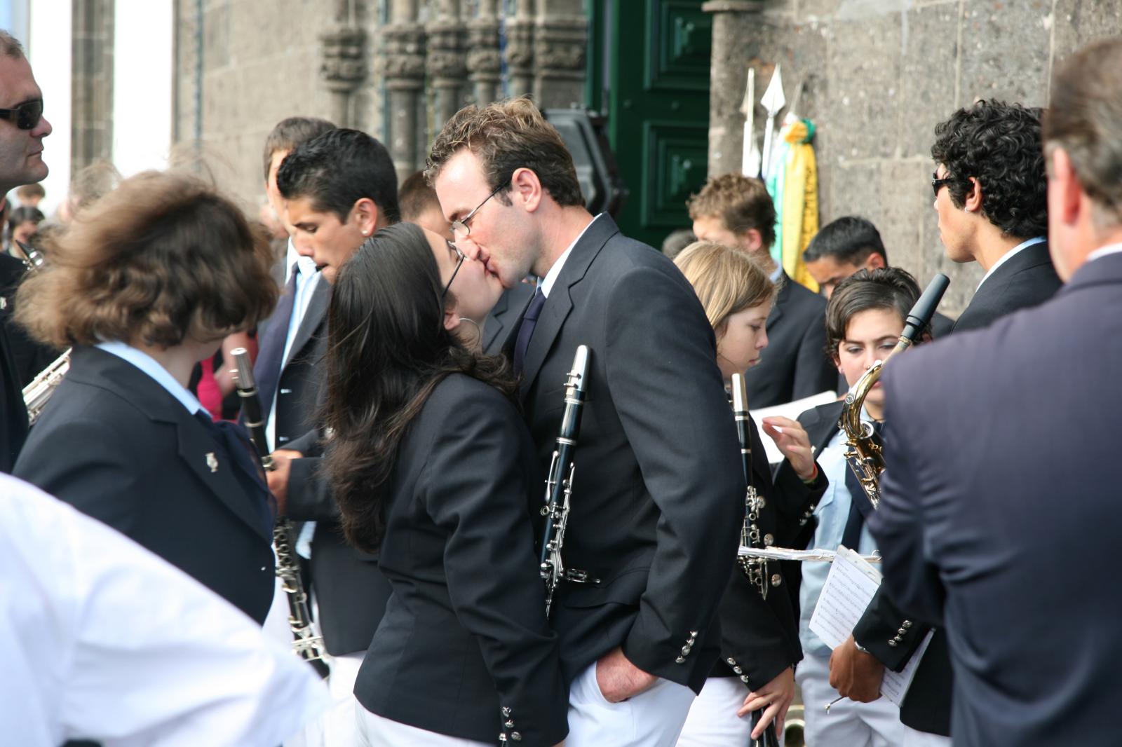 Two musicians from Vila Franca ...chestra kissing during a break.