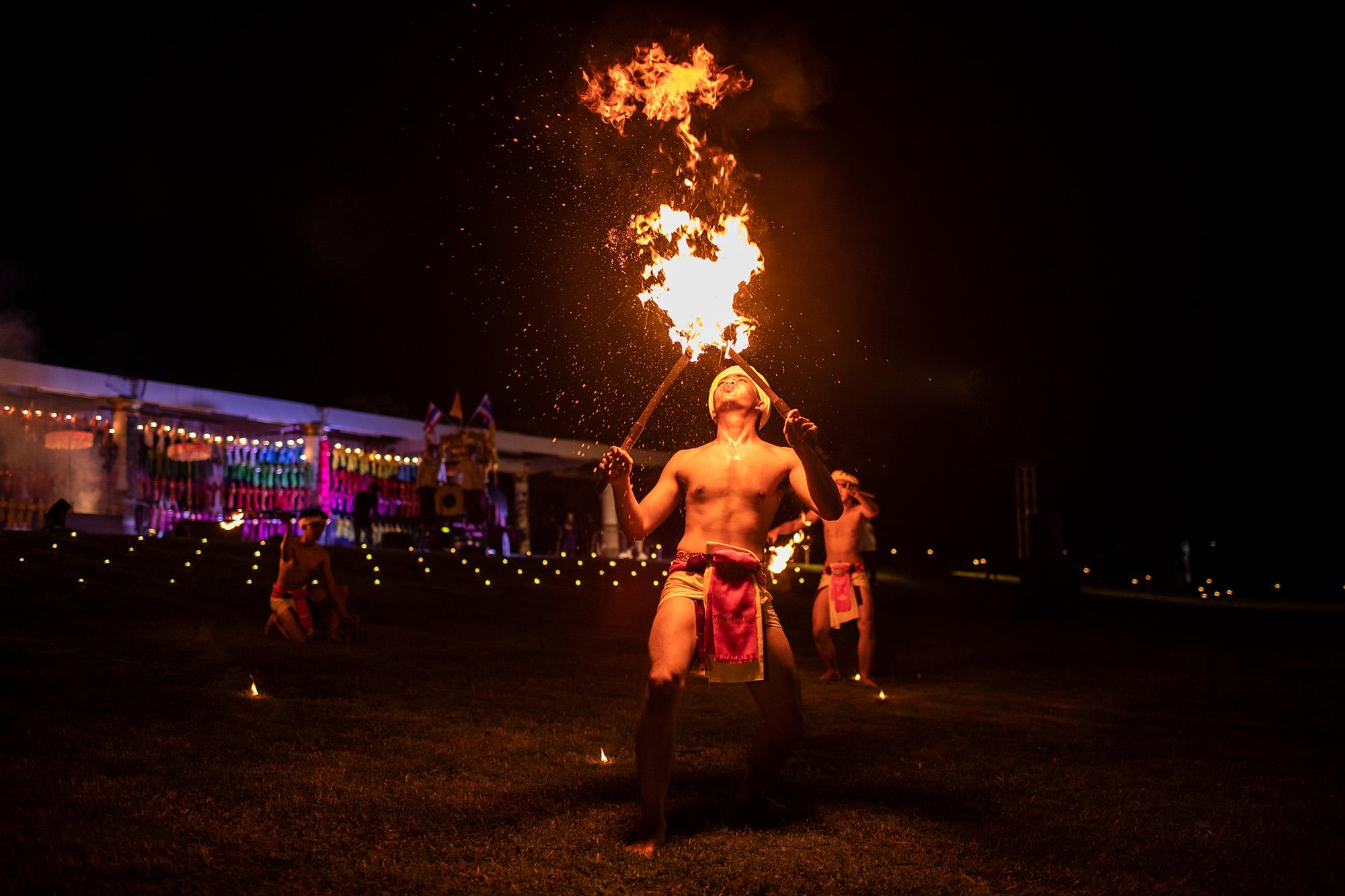 A fire dancer performs at an event near Chiang Mai, Thailand, November 2021.