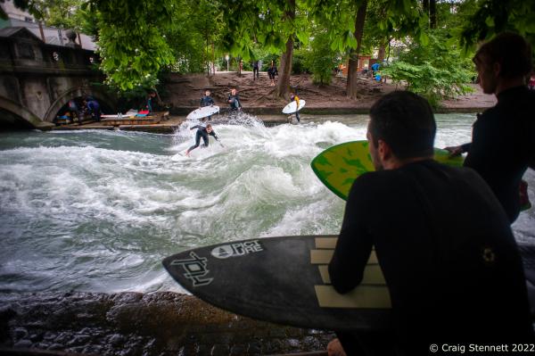 MUNICH, GERMANY - JUNE 15: Surfing the &#39;Standing Wave&#39; of the Eisbachwelle in Munich, Bavaria in 2019. The Eisbach (Ice Brook) is a 2 kilometer man made river which is a canal tributary from Bavaria&lsquo;s Isar River. The narrow channel effect of the canal produces 8 tons of water per second rushing through the middle of Munich&lsquo;s Englischer Garten, a public park, and is the hub of the land locked city&rsquo;s surf scene. The river, following enhancement from local surfers, produces a standing wave called the Eisbachwelle (Ice Brook Wave). It has been surfed in the city since the early 1970&rsquo;s. Munich now claims to be home to some 2000 full time surfers.(Photo by Craig Stennett/Getty Images)