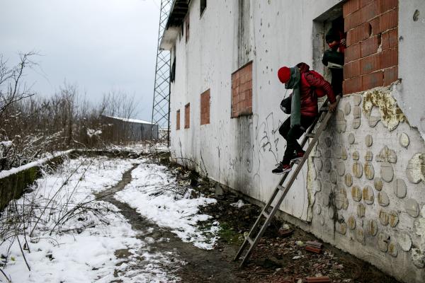 A group of Afghan refugees heading out of an abandon building they stayed in, for &quot;The Game&quot;, a nickname given by refugees to their relentless attempts, crossing the Bosnian-Croatian border, without being detected and pushed back by Croatian border police. Bihac, Bosnia.