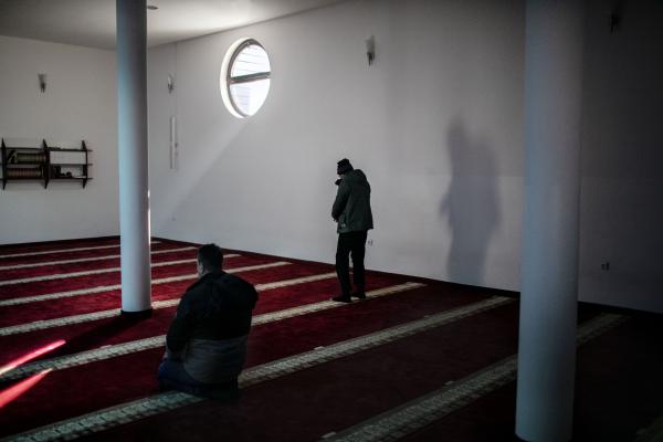 A refugee from Afghanistan (centre) praying in one of the mosques of the city of Bihac. during Friday prayers some refugees are going to the mosques in the city in order to pray.