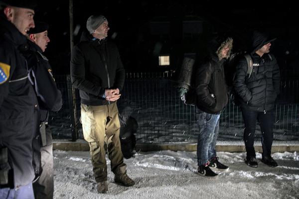 A group of refugees from Iran (2 of them on the right), who were pushed back by the Croatian border police while trying to cross the Bosnian-Croatian border, waiting on the main road near Bihac city. Bosnian police called the SOS Bihac organisation to come and help the refugees.  