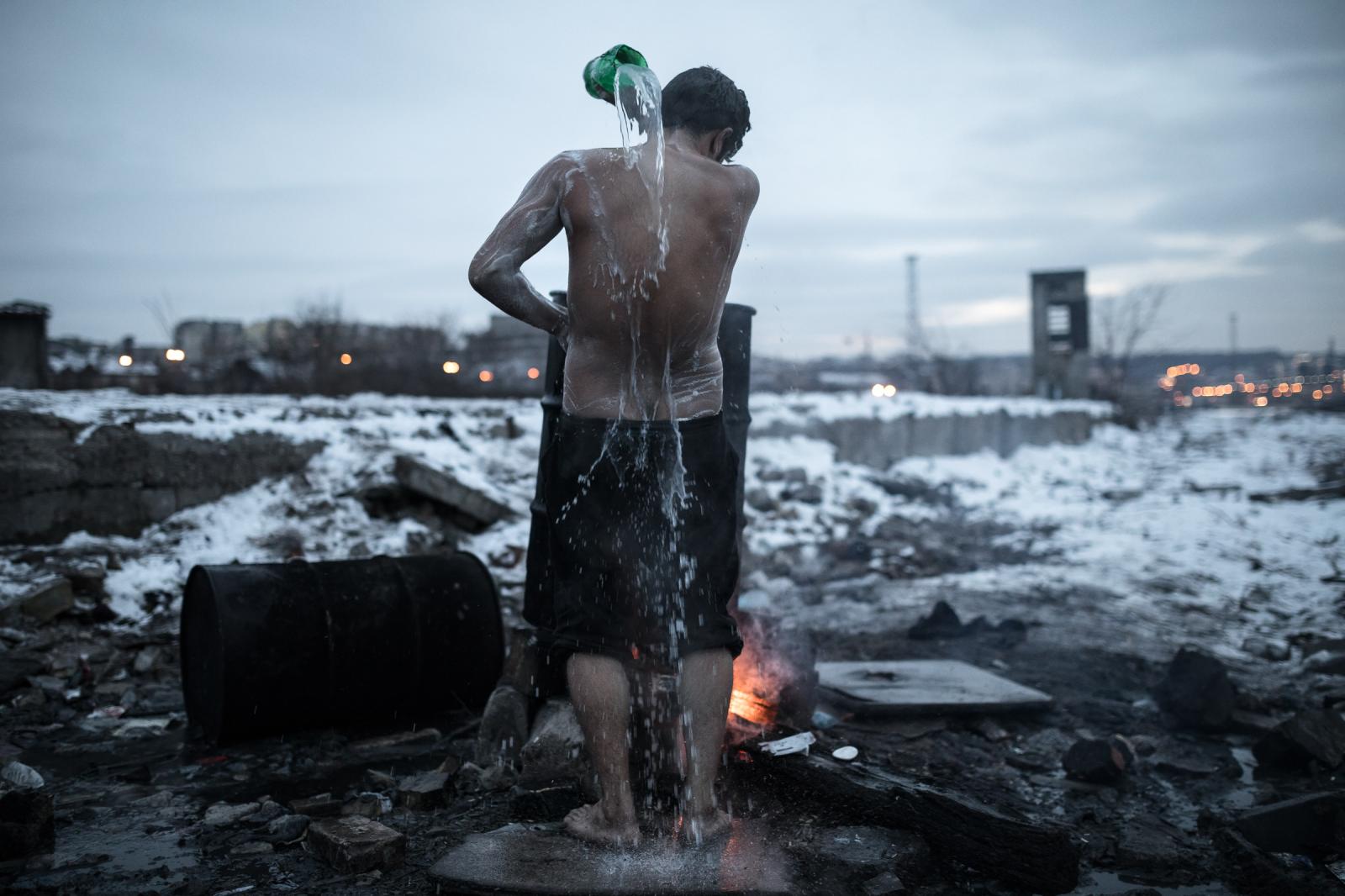 An Afghan migrant washes his bo...ward toward the central Europe.