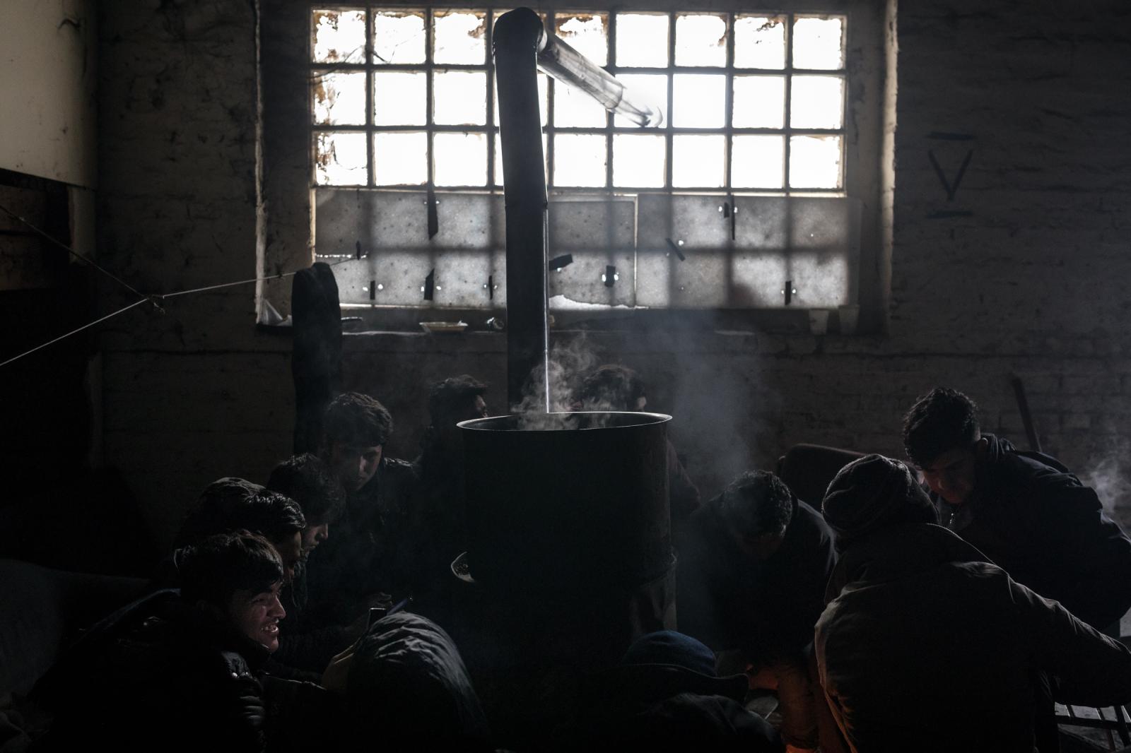 Afghan migrants trying to warm ...ward toward the central Europe.