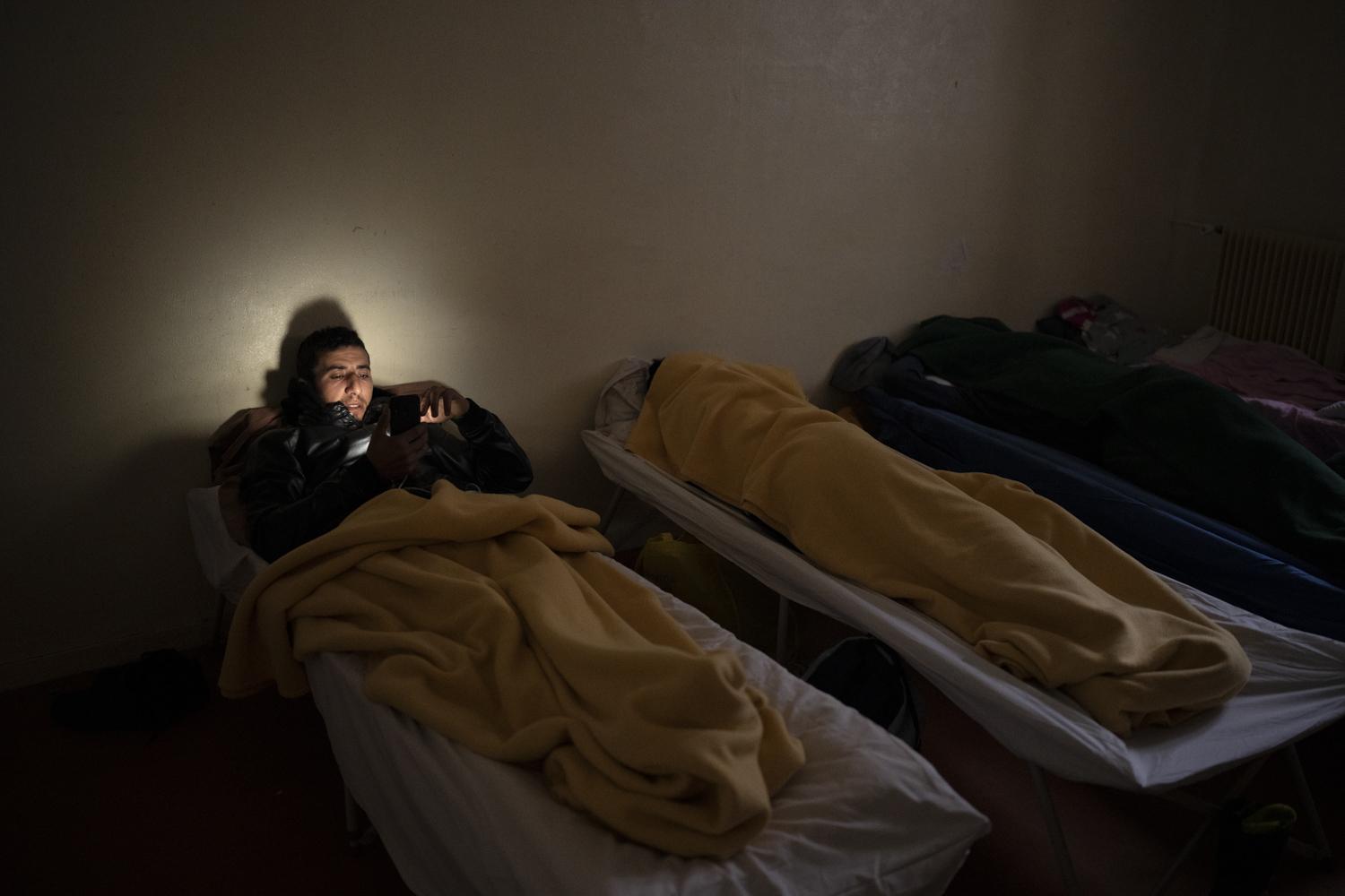 Youssef Alami, 29, from Morrocco rests at a migrant refuge in Briancon, France, after having...