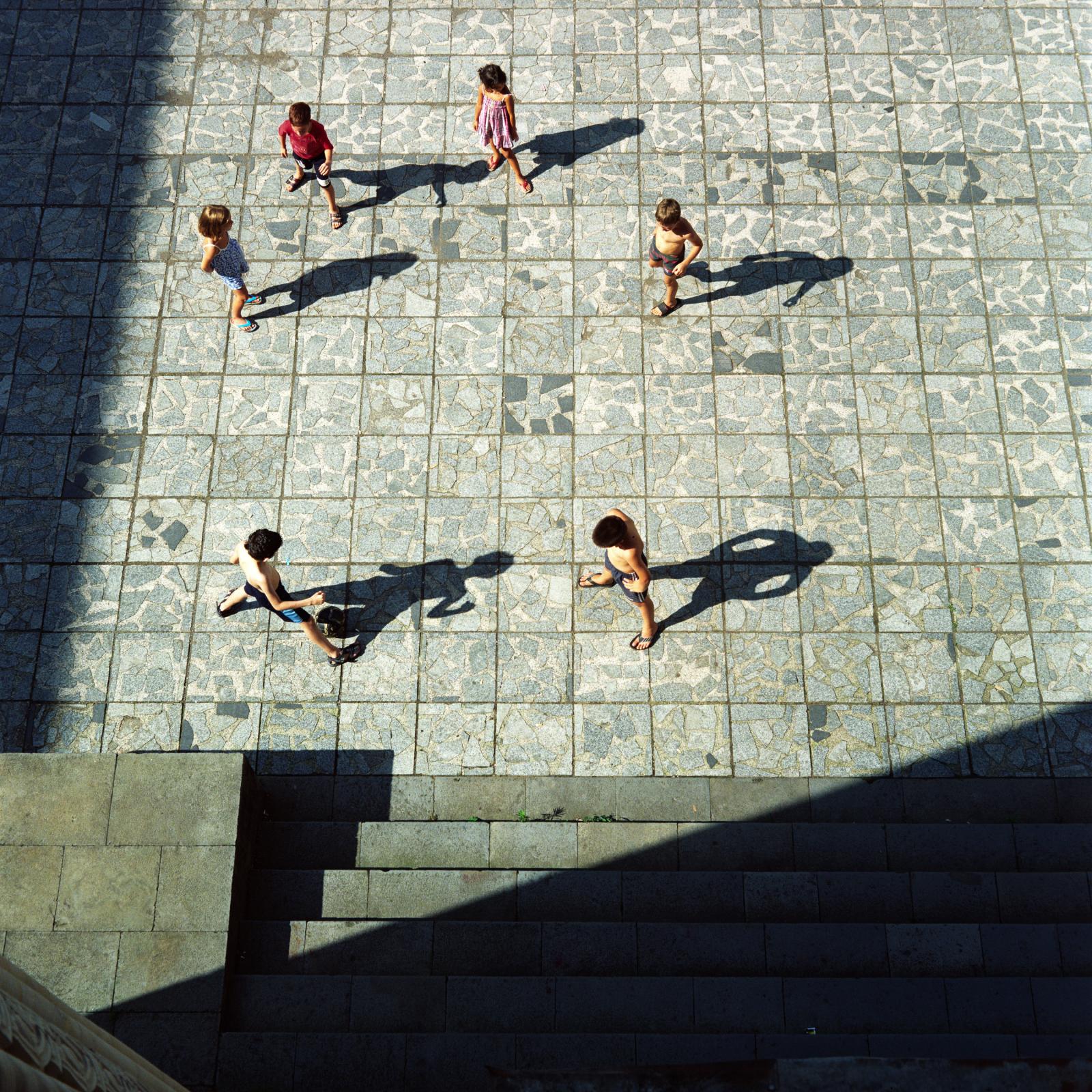 A forest on the roof (ongoing) - Children are playing freeze tag in the inner courtyard of...