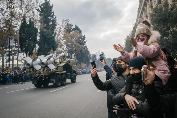 Baku, Azerbaijan, December 10th, 2020. Military parade following the recapture of the Armenian territories of Nagorno-Karabakh. The Azeri President Aliyev receives Erdogan, who militarily supported the offensive against the Armenians. During the parade, family come together to watch the show.