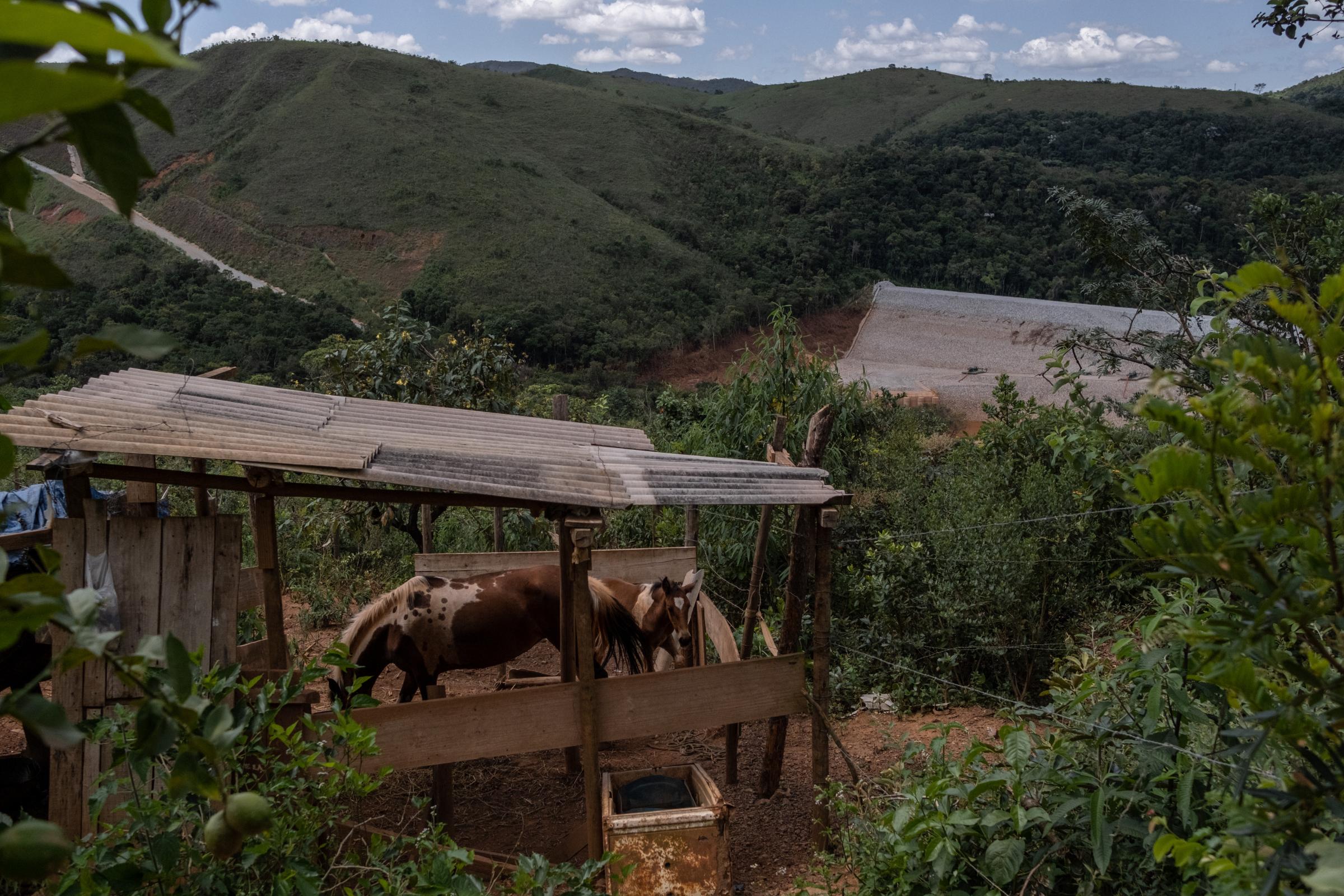 Three Years Later: Deadly Mining Disaster Still Tests Vale and Mining Towns Live in Fear of Another Dam Collapse - Sandra Ribeiro&#39;s home looks over the contention wall that was built by mining company...