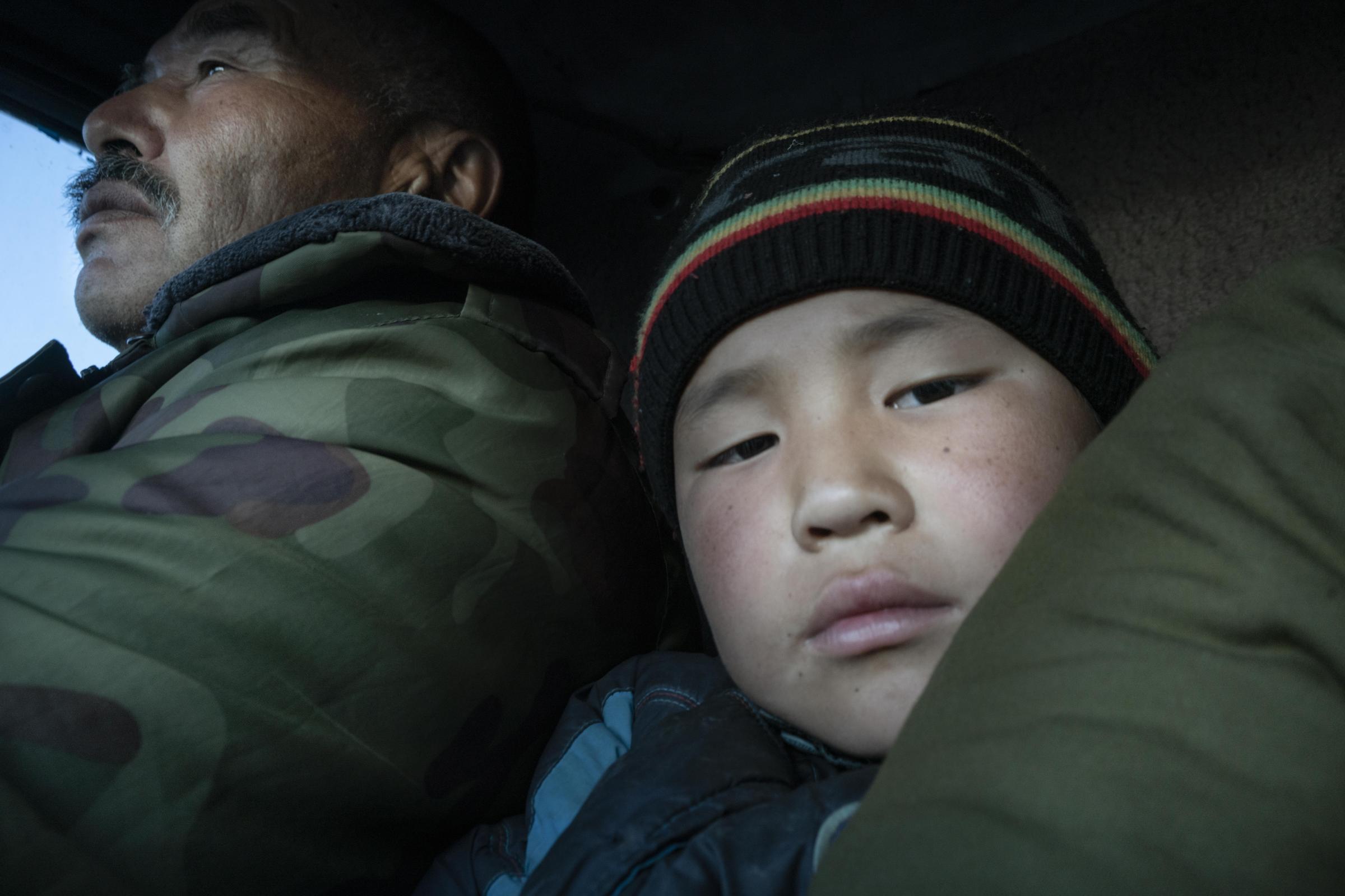 Nomads - Arsanaliev Zamir (65) and his grandson Tarstan (10) riding to the first yurt camp in a rented...