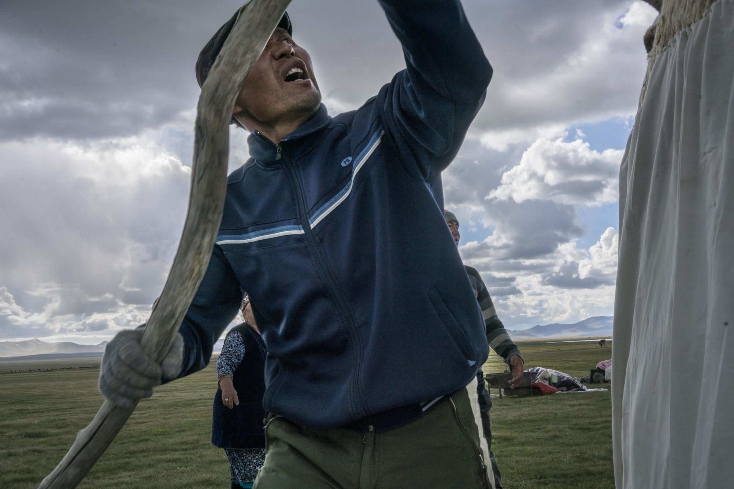 Nomads - Sergey (37) helps erect a yurt. Yurts typically take one hour to assemble. Song Kul, Kyrgyzstan....
