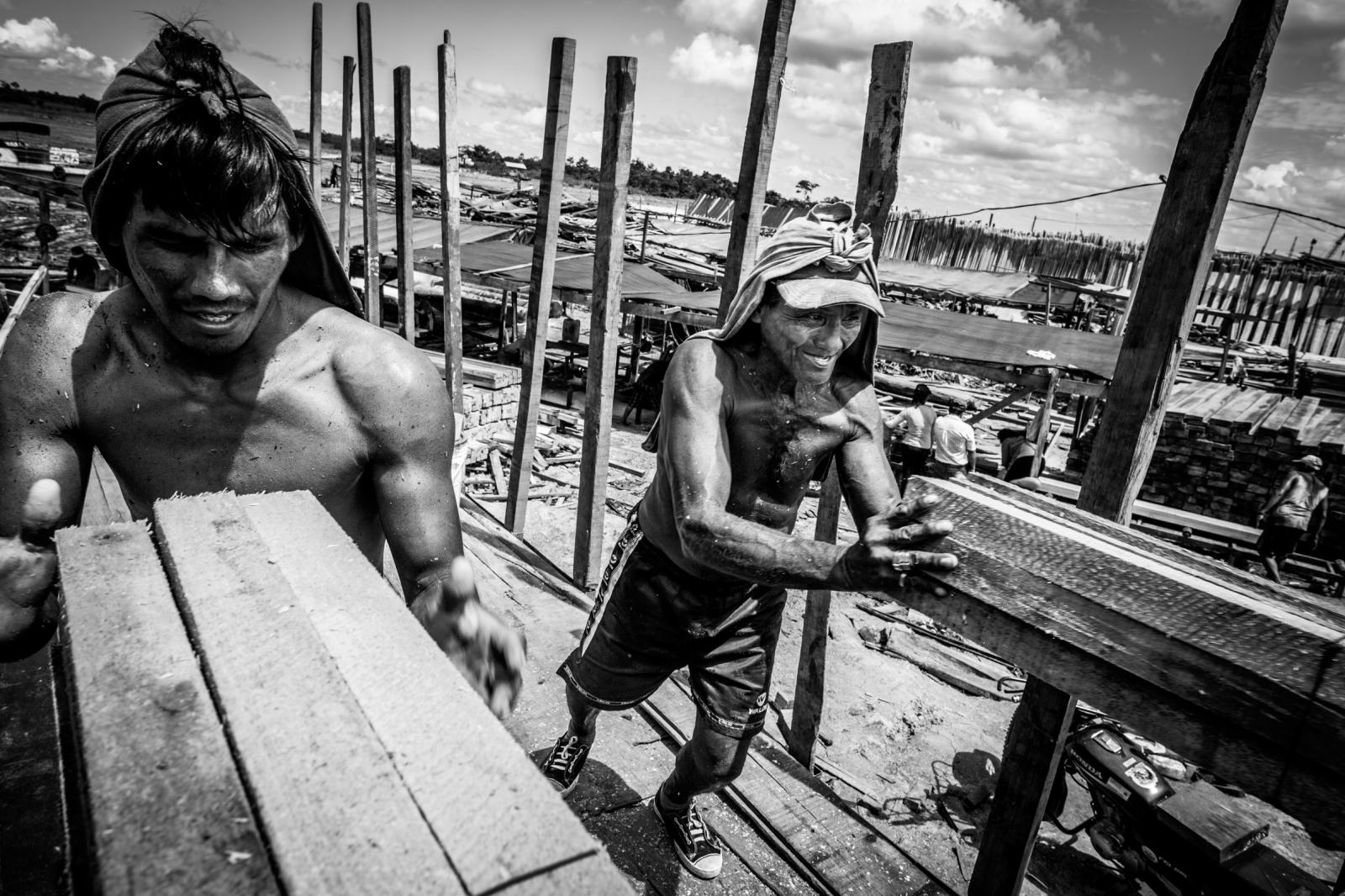Workers loading lumber on a tru...ted at eight Pucallpa sawmills.