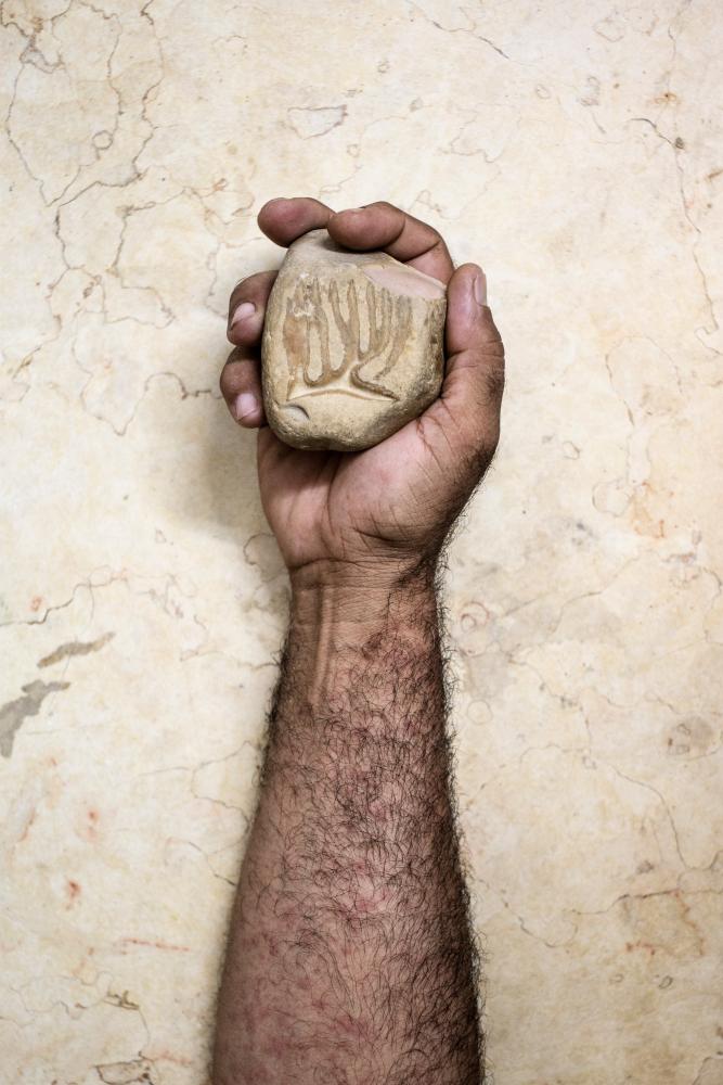 Nour Eldein Zaki holds a stone ...ormation is so rare that it can