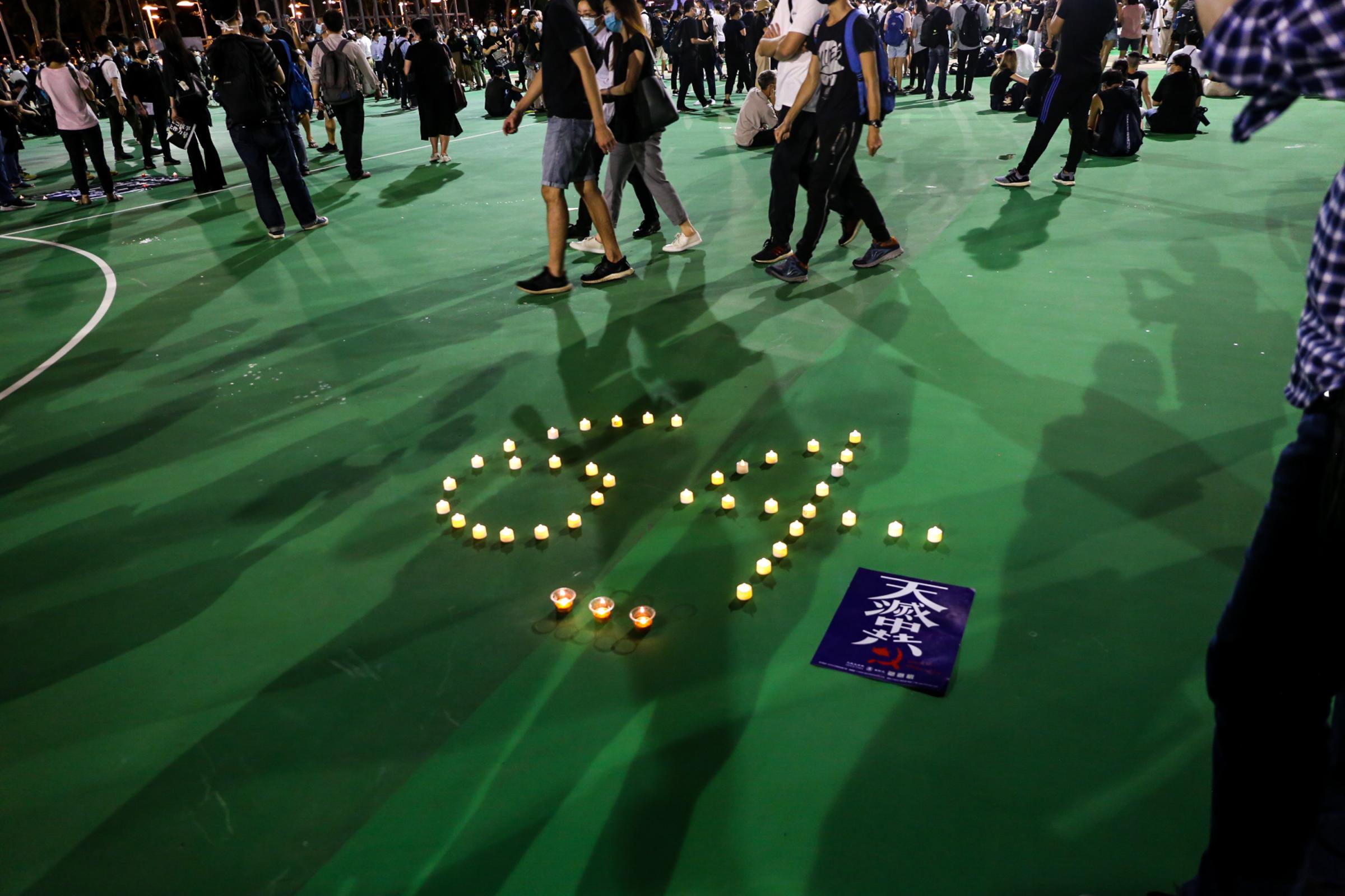[2019-2021] Hong Kong Protests: Behind the Front Lines - Candles arranged in the number of "6" and...