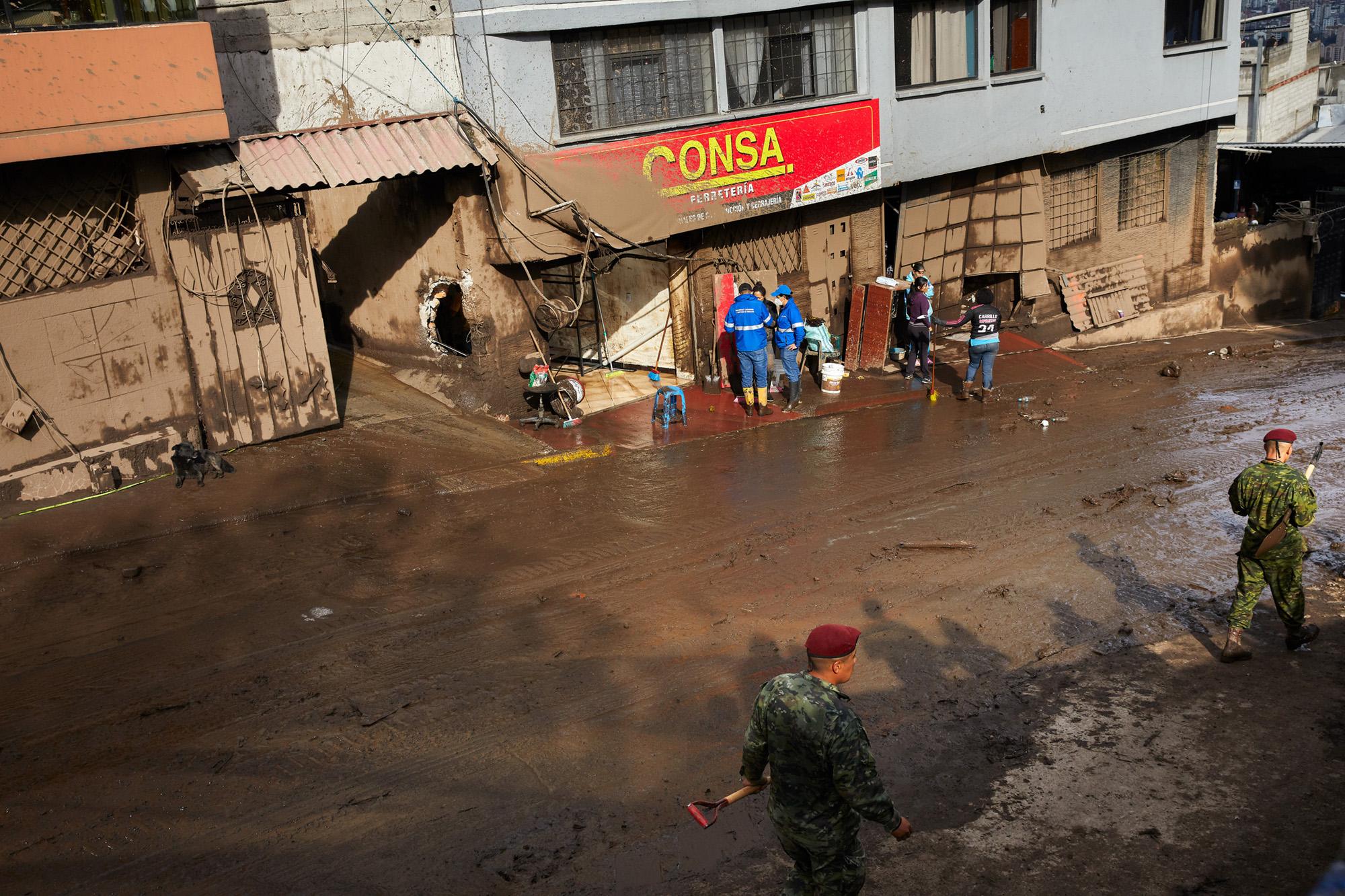 Rescue and military groups check affected areas after a mudslide in Quito, Ecuador, Tuesday, Feb....