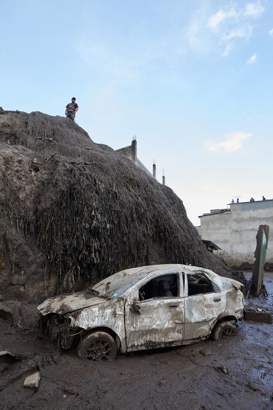 Several cars were dragged more than 200 meters and were buried in mud after a mudslide in Quito,...