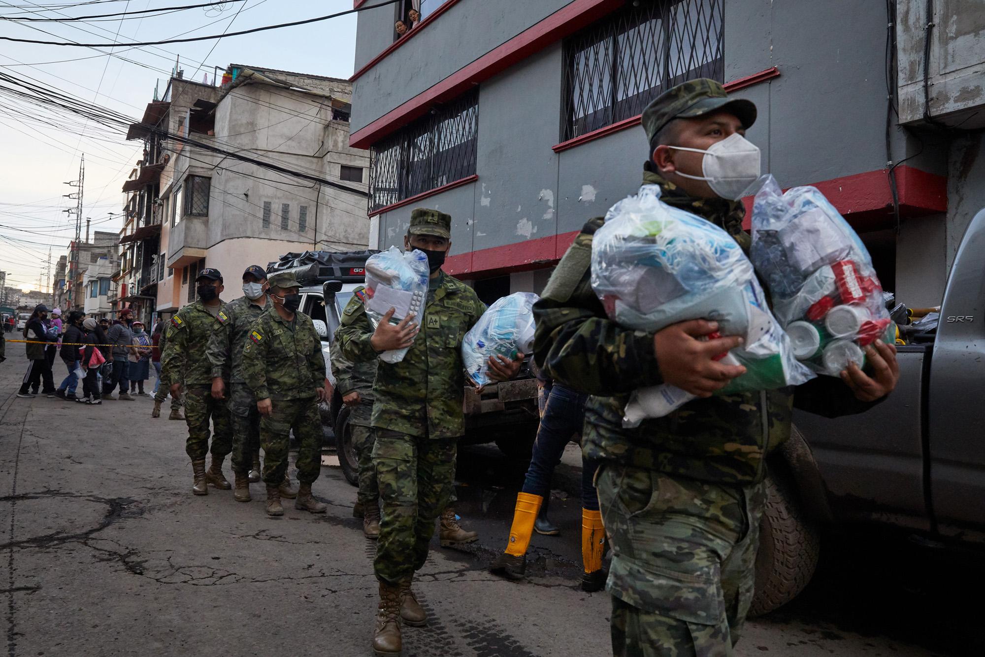 Military personnel assisting in rescue efforts after a mudslide in Quito, Ecuador, Tuesday, Feb....