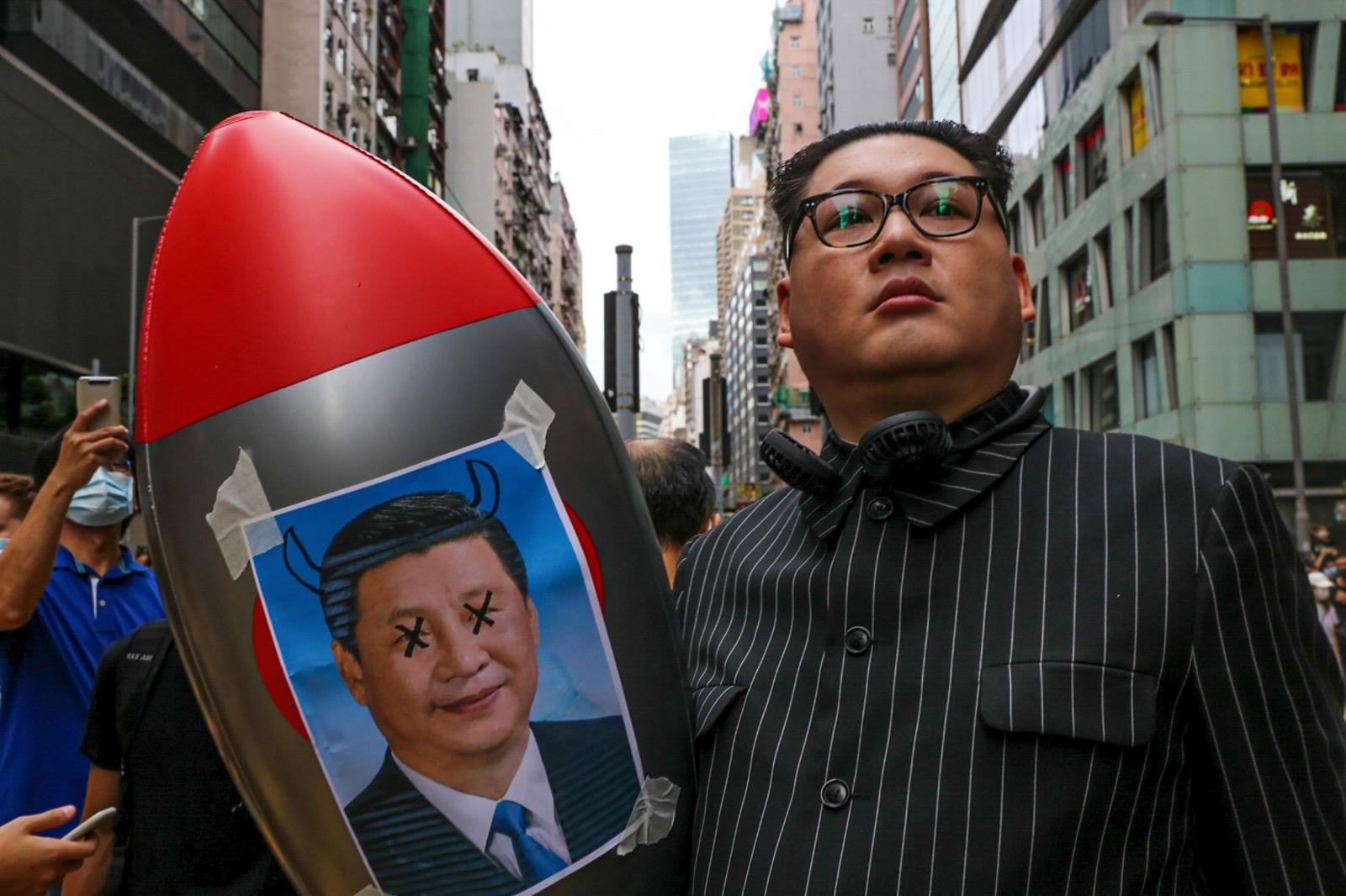 Howard X, a Kim Jung Un impersonator, holds a plstic blow-up missile with a photo of Xi Jinping. On the first day of the passing of the National Security Law, thousands came out to protest in defiance. Composed of 66 articles that redefine acts of secession, subversion, terrorism, and foreign collusion, acts such as this can be punishable up to life imprisonment.