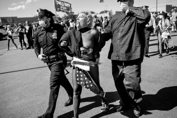 An anti Trump activist is arrested and taken to a police car during a "New York Triumph Rally", a Donald Trump supporters’ rally in Staten Island.