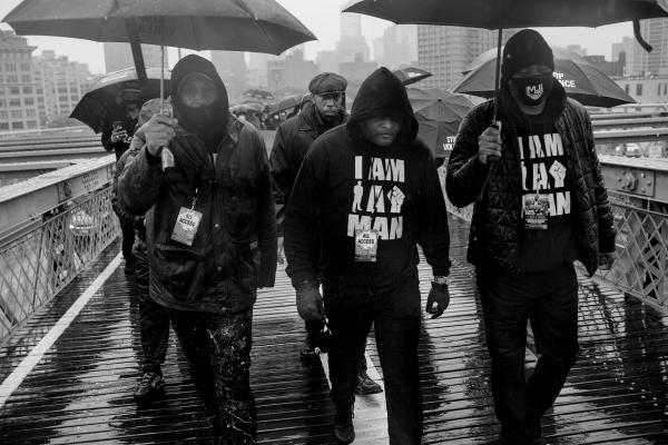 On the 25th anniversary of the Million Man March, A.T Mitchel (center) the founder of ManUp Inc, a local grassroot organisation in East New York, leads the 500X5, a united men of colour initiative, over the Brooklyn Bridge.