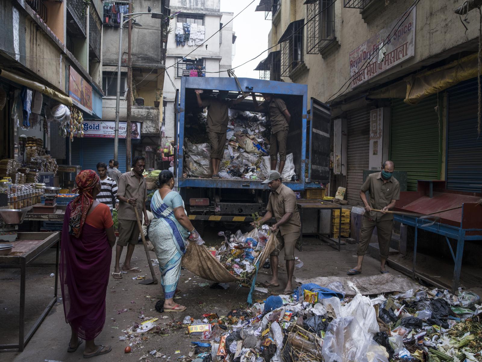 Mumbai city workers clean up th...reets during their daily work. 