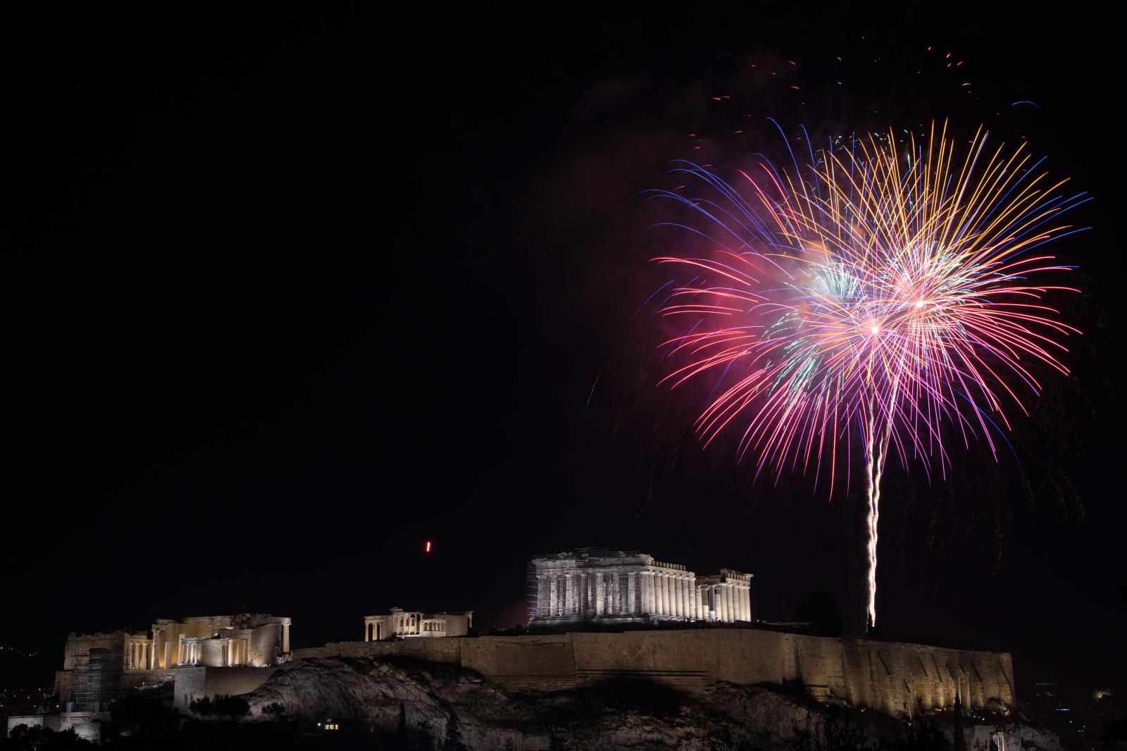 Fireworks go up next to the Parthenon on Acropolis Hill. Athens, January 1, 2022.
