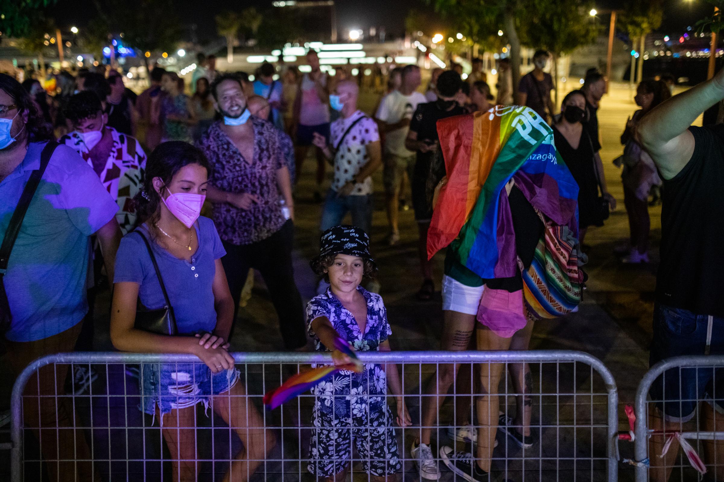 IBIZA, SPAIN - SEPTEMBER 17: Participants enjoy gay pride day as a couple kiss under the rainbow flag on September 17, 2021 in Ibiza, Spain. The...
