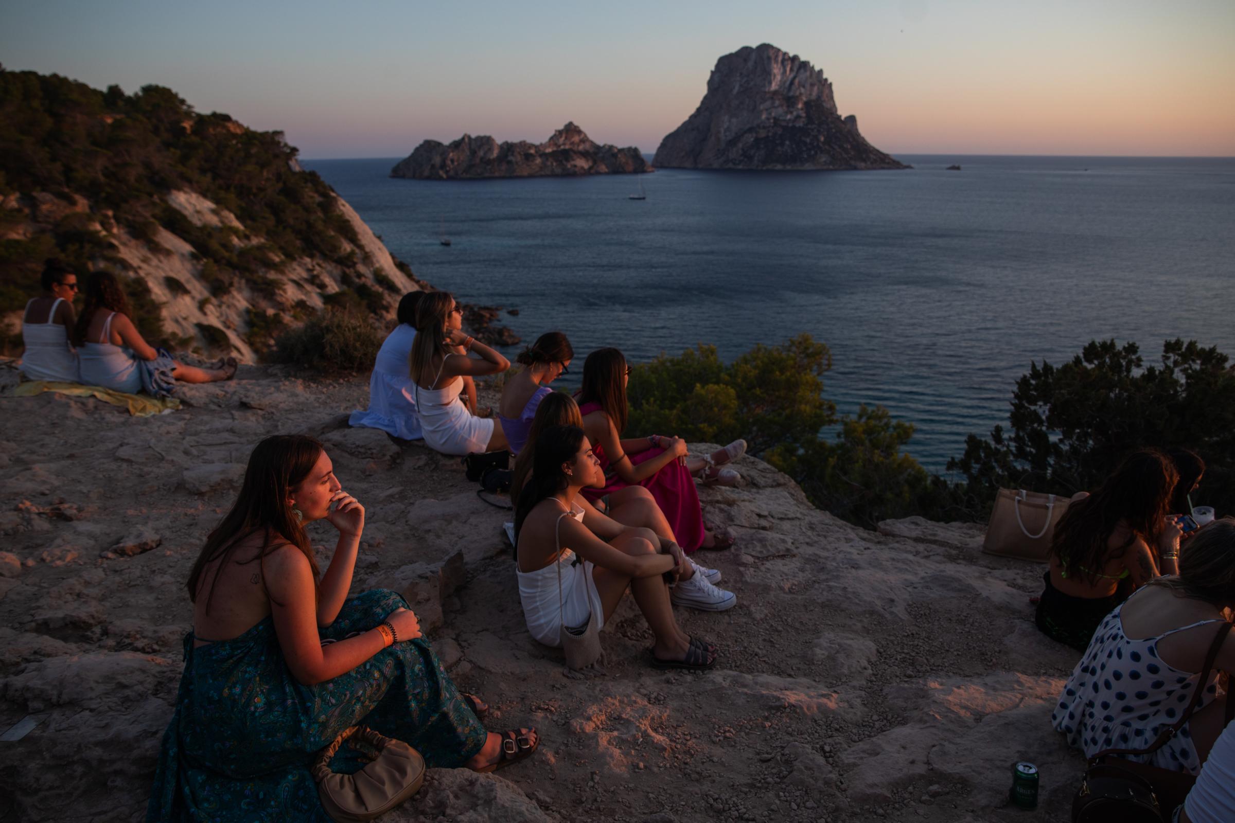 Covid-19: Ibiza Added To UK Amber Travel List - IBIZA, SPAIN - JULY 16: People enjoy the sunset at the Es...