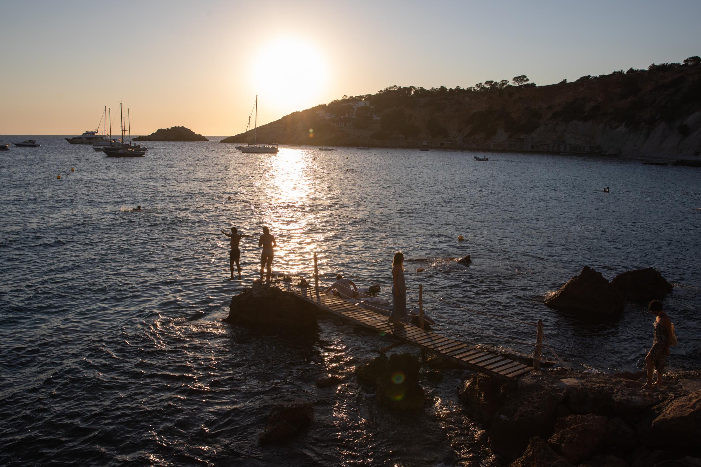 Covid-19: Ibiza Added To UK Amber Travel List - IBIZA, SPAIN - JULY 16: Unidentified youth jump into the...