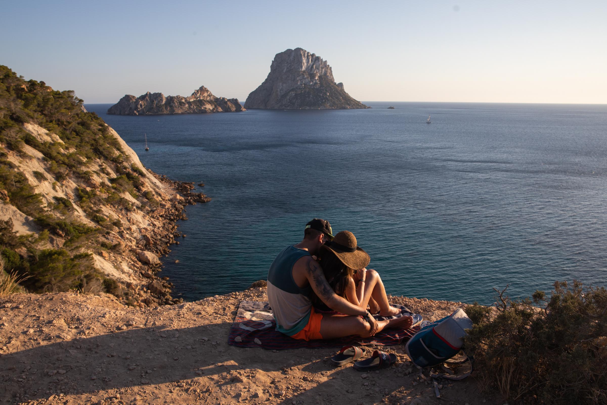 Covid-19: Ibiza Added To UK Amber Travel List - IBIZA, SPAIN - JULY 16: An unidentified couple hug while...