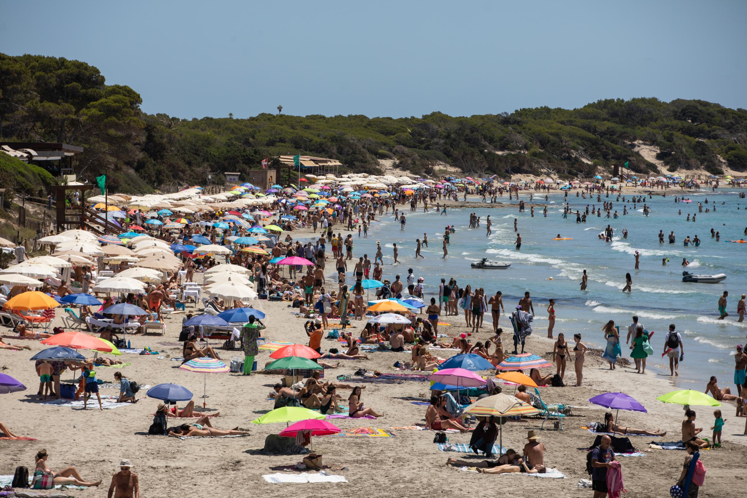 Covid-19: Ibiza Added To UK Amber Travel List - IBIZA, SPAIN - JULY 16: Ses Salines Beach full of bathers...