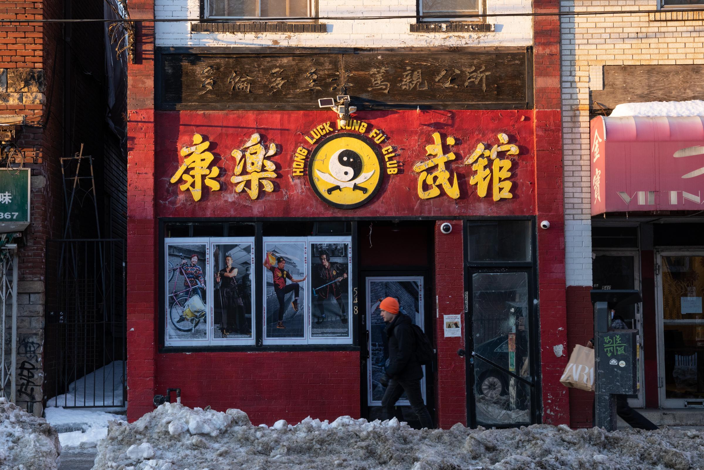 A person walks by the Hong Luck Kung Fu Club on the edge of Toronto’s Chinatown on January 20, 2022. Portraits from the ‘Best of Chinatown’ window...