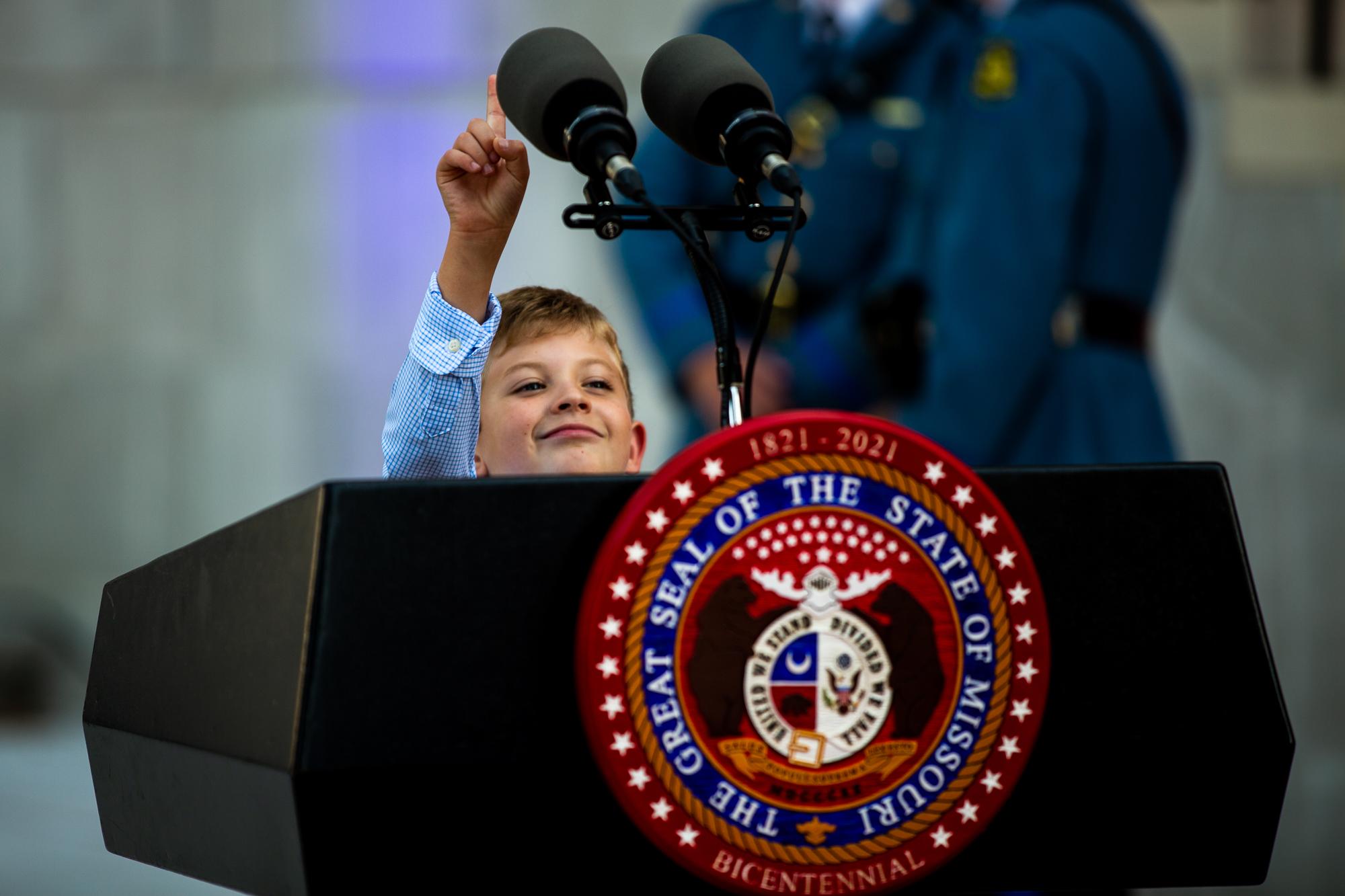 Hunter Chapman, 9, reaches for the podium microphones ahead of the Missouri Bicentennial Ball on Saturday, September 18, 2021 in Jefferson City, Mo. &ldquo;He&rsquo;s a future president,&rdquo; his mom said.