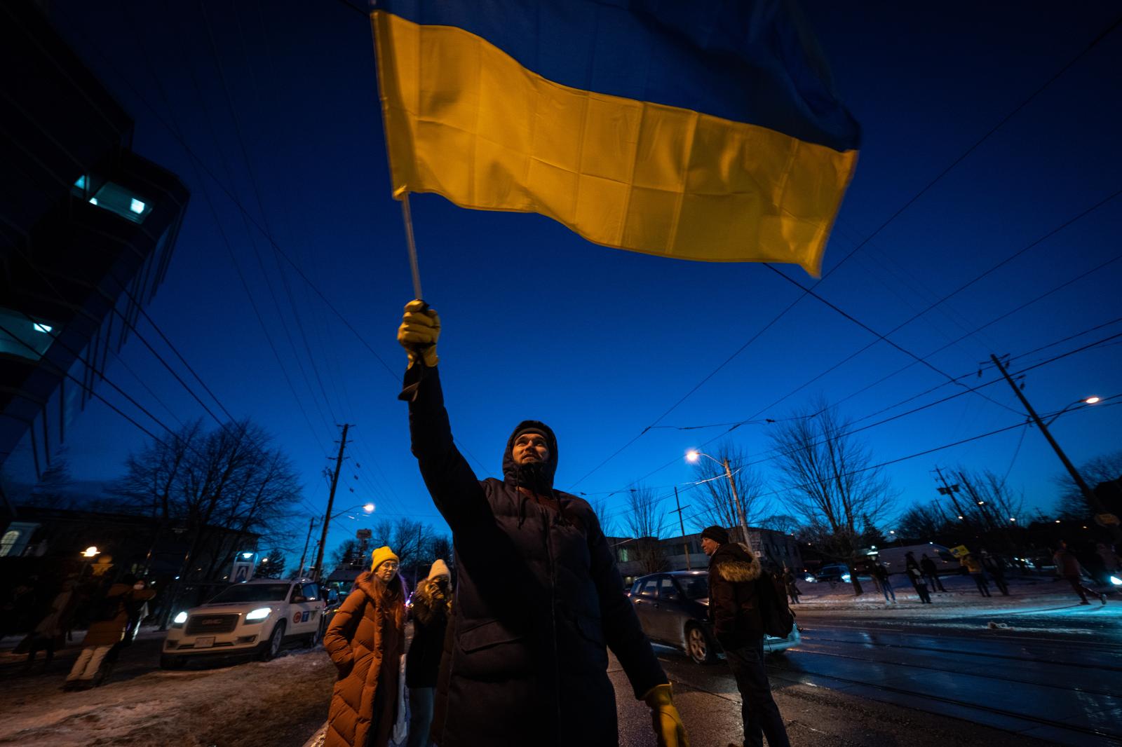 A protestor waving a Ukrainian ...o, Canada on February 25, 2022.