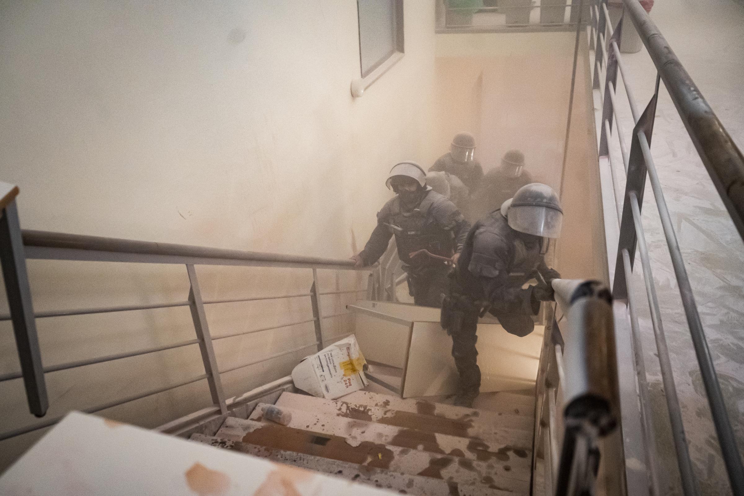 Anti-riot police of the Mossos de Esquadra try to access the top floor of the University of...