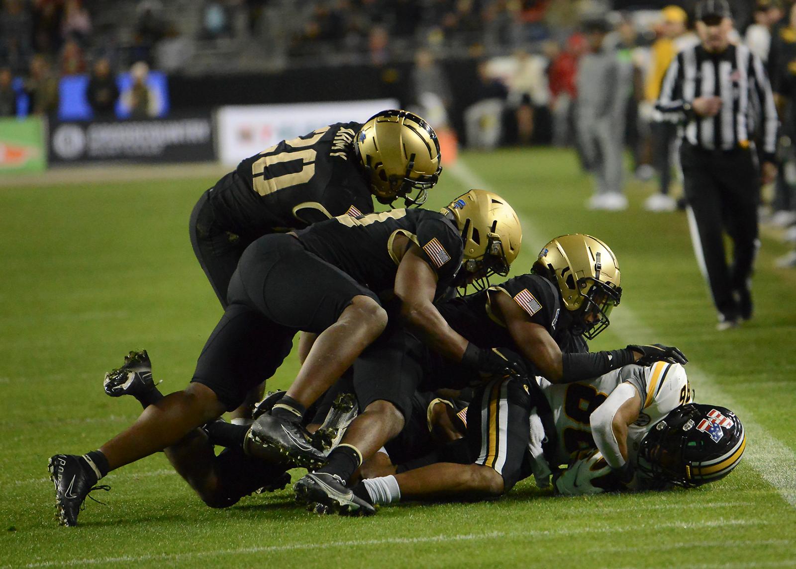 Tauskie Dove gets tackled by army players during the Armed Forces Bowl on Wednesday at Amon G. Carter Stadium in Fort Worth, Texas.