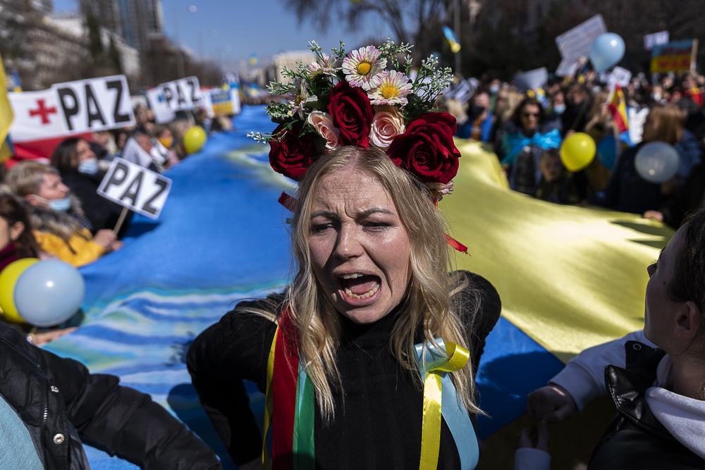 A woman shouting slogans agaist...he Russian invasion of Ukraine.