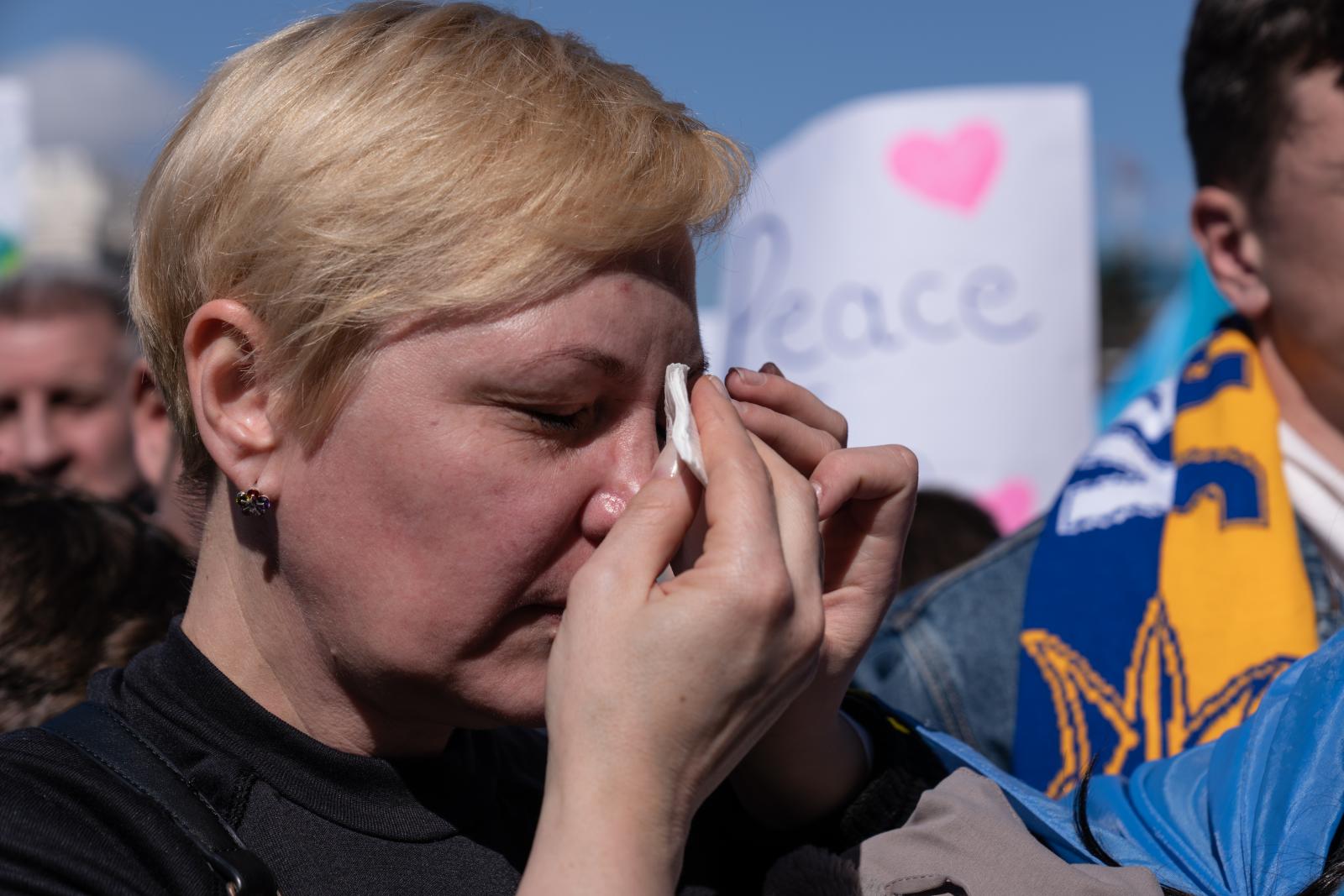 A woman wiping hear tears durin...he Russian invasion of Ukraine.